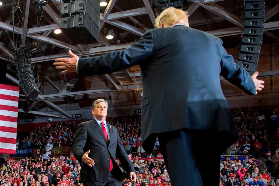 Donald Trump greets Sean Hannity at a 2018 rally.