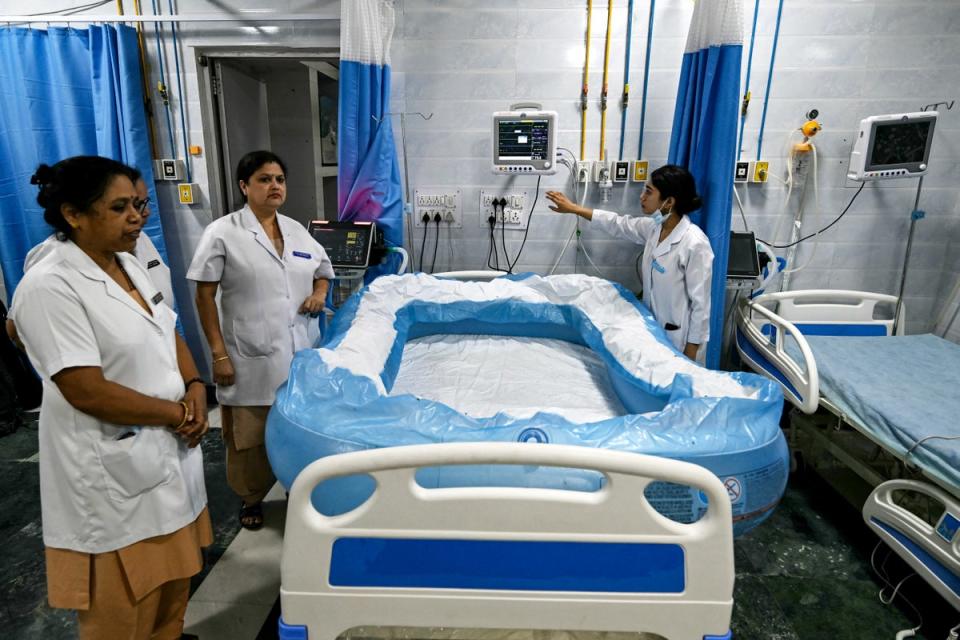 Staff prepare an inflated ice bed in the heatstroke ward of Ram Manohar Lohia hospital in Delhi (AFP via Getty)