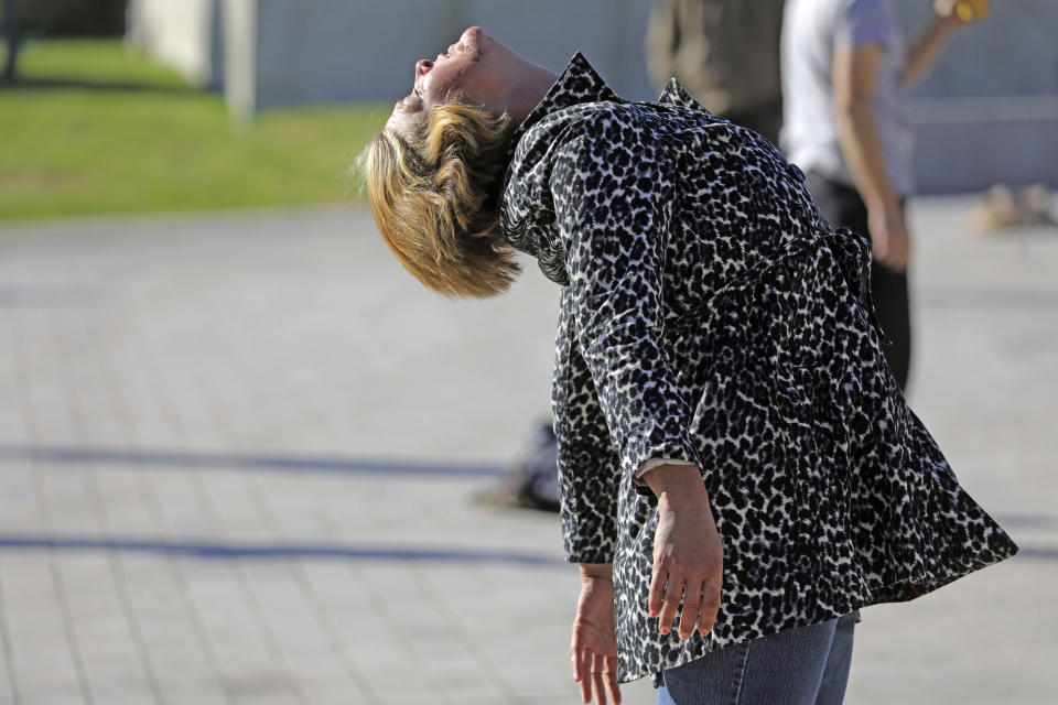 In this Oct. 7, 2019, photo, Allysha St. Clair performs tai chi at the Salt Lake City Public Library, in Salt Lake City. The participants are homeless people. (AP Photo/Rick Bowmer)