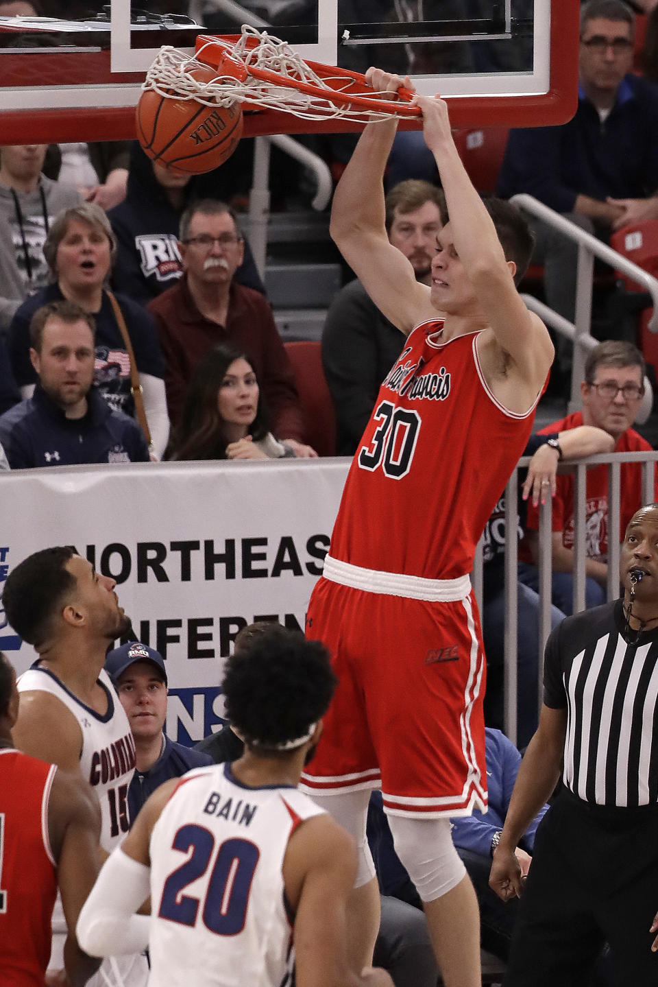 St. Francis' Deivydas Kuzavas (30) dunks during the first half against Robert Morris during an NCAA college basketball game for the Northeast Conference men's tournament championship in Pittsburgh, Tuesday, March 10, 2020. (AP Photo/Gene J. Puskar)