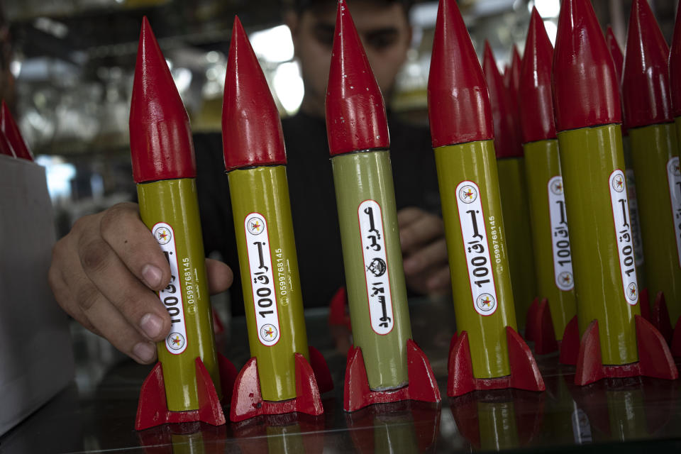 Belal Abu Saraya arranges perfume containers representing rockets used against Israel in a perfume store against Israel in past conflicts at his shop in Gaza City on Thursday, Oct. 5, 2023. AP Photo/Fatima Shbair)