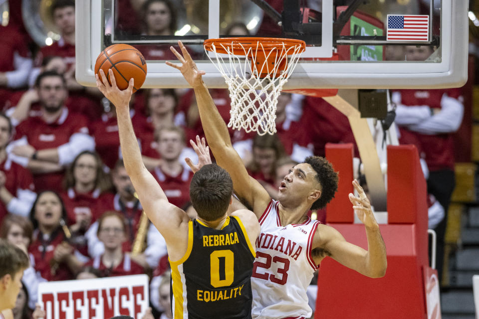 Iowa forward Filip Rebraca (0) shoots as Indiana forward Trayce Jackson-Davis (23) defends during the second half of an NCAA college basketball game Tuesday, Feb. 28, 2023, in Bloomington, Ind. (AP Photo/Doug McSchooler)