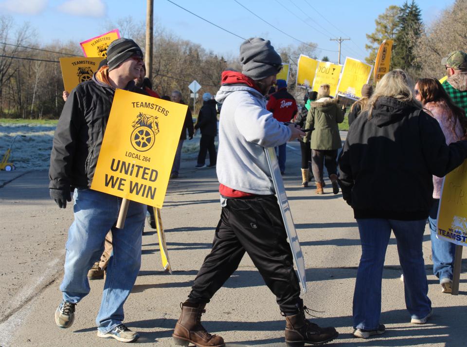 Members of Teamsters Local 264 walk the picket line outside Friendship Dairies in Allegany County Friday morning. More than 230 employees are on strike.