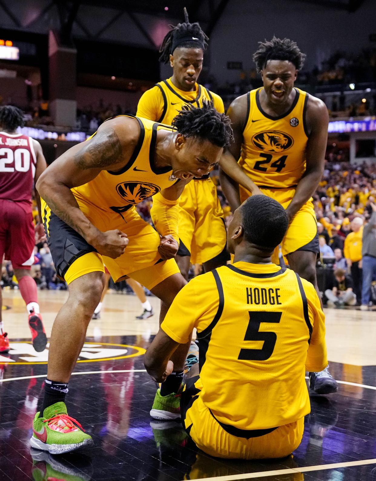 Missouri Tigers guard D'Moi Hodge (5) is congratulated by guard DeAndre Gholston (4) and guard Sean East II (55) and guard Kobe Brown (24) after taking a charge late in the second half against the Arkansas Razorbacks at Mizzou Arena.
