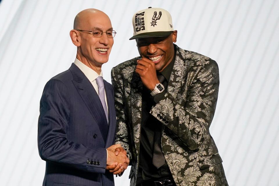 Malaki Branham reacts as he shakes hands with NBA Commissioner Adam Silver after being selected 20th overall in the NBA basketball draft, Thursday, June 23, 2022, in New York. (AP Photo/John Minchillo)