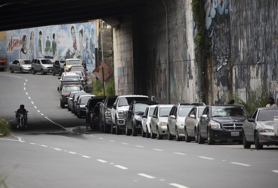 Vehicles line up near a gas station to fill their tanks in Caracas, Venezuela, Tuesday, Sept 8, 2020. Gasoline shortages have returned to Venezuela, sparking mile-long lines in the capital as international concerns mounted that Iran yet again may be trying to come to the South American nation's rescue. (AP Photo/Ariana Cubillos)