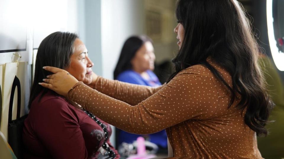 Nicole Akan, from Muskowekwan First Nation, does makeup at a Mother's Day event in her home community.