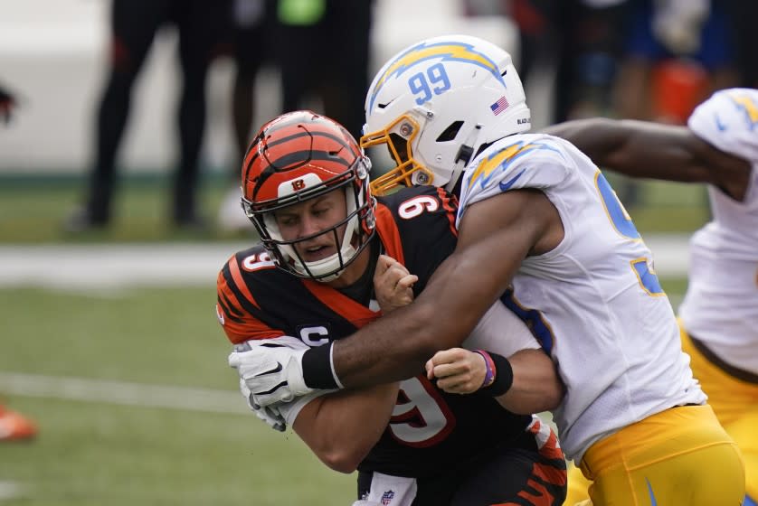 Cincinnati Bengals quarterback Joe Burrow (9) is hit by Los Angeles Chargers' Jerry Tillery.