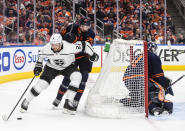 Los Angeles Kings' Alexander Edler (2) and Edmonton Oilers' Leon Draisaitl (29) battle for the puck during the third period of Game 1 of an NHL hockey Stanley Cup first-round playoff series, Monday, May 2, 2022 in Edmonton, Alberta. (Jason Franson/The Canadian Press via AP)