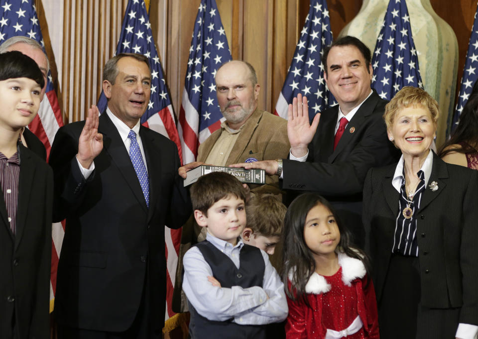 Rep. Alan Grayson, D-Fla., stands with his family for a ceremonial photo with Speaker of the House John Boehner, R-Ohio, left, in the Rayburn Room of the Capitol after the new 113th Congress convened on Thursday, Jan. 3, 2013, in Washington. The official oath of office for all members of the House was administered earlier in the House chamber. (AP Photo/J. Scott Applewhite) 