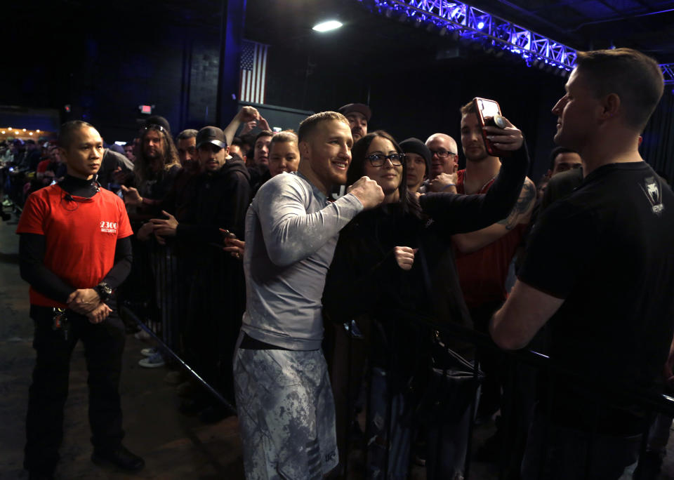 In this Wednesday March 27, 2019, photo, UFC fighter Justin Gaethje poses with fans after a workout in Philadelphia. Gaethje fights Edson Barboza in a lightweight bout in the main event of the UFC card in Philadelphia on March 30. The bout features two of the most ferocious kickers in the sport, who are both coming off wins following two straight losses. Gaethje viewed the fight as an elimination bout of sorts for each fighter to stay in the hunt for a championship match against Khabib Nurmagomedov. (AP Photo/Jacqueline Larma)