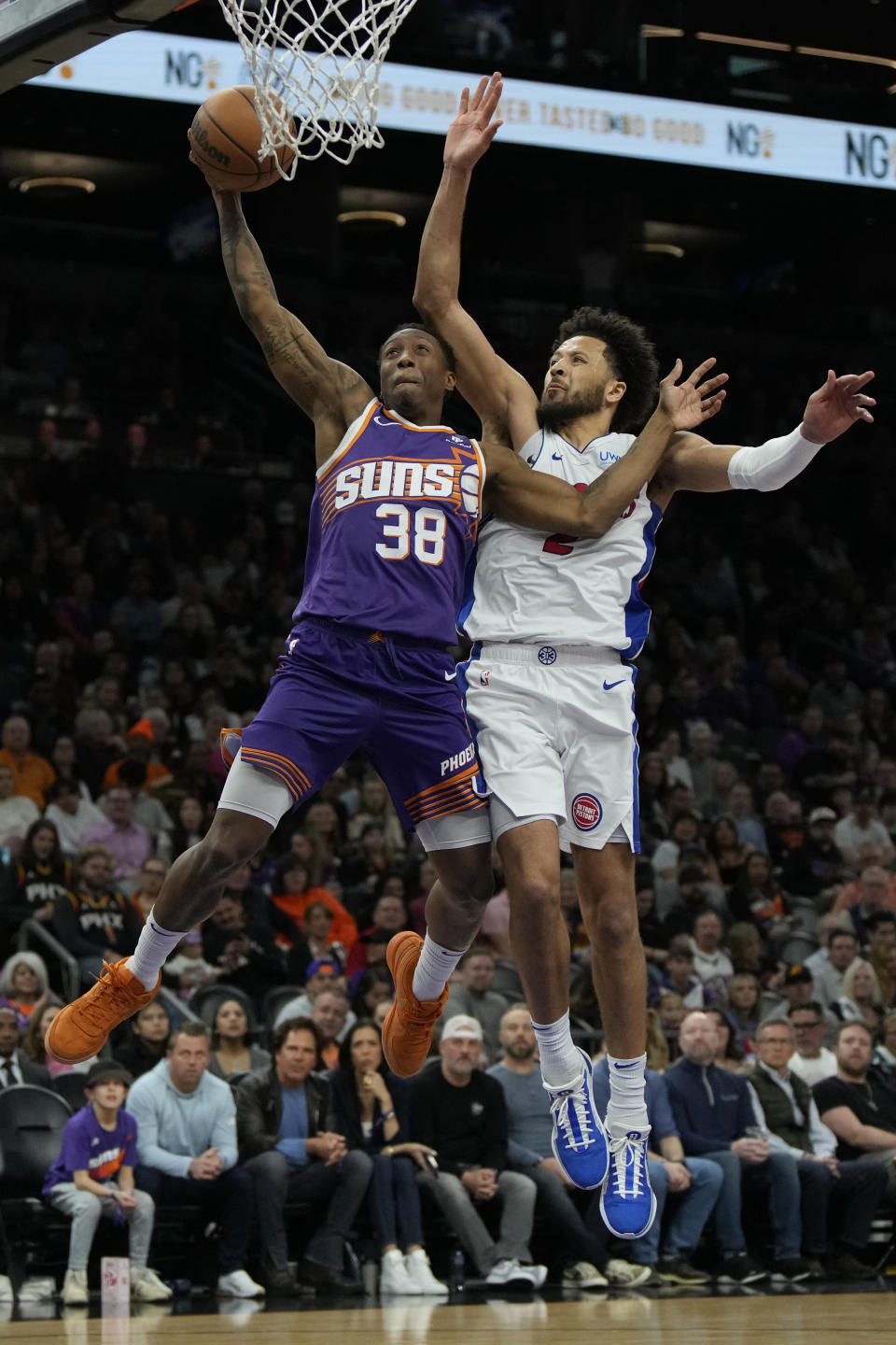 Phoenix Suns guard Saben Lee (38) drives on Detroit Pistons guard Cade Cunningham during the second half of an NBA basketball game, Wednesday, Feb. 14, 2024, in Phoenix. (AP Photo/Rick Scuteri)