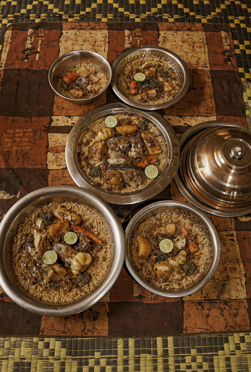 Bowls of Senegal's national dish, thieboudienne, are prepared for lunch in Diamniadio, Senegal, on May 31, 2022. (AP Photo/Grace Ekpu)