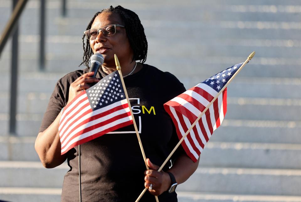 Darlene McDonald, Utah Black Roundtable Chair, speaks during a vigil honoring Americans who died because they were Black, on the 60th anniversary of the March on Washington for Jobs and Freedom in front of the capitol in Salt Lake City on Monday, Aug. 28, 2023. She holds American flags to show she can love America and criticize it at the same time. | Kristin Murphy, Deseret News