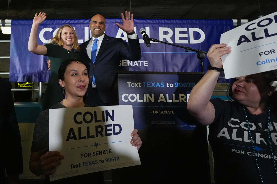 U.S. Senate hopeful Colin Allred, D-Texas, top right, stands on stage with his wife, Aly Eber, during a primary-night gathering, Tuesday, March 5, 2024, in Dallas. (AP Photo/Julio Cortez)