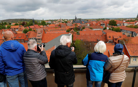 Tourists watch the city skyline of Quedlinburg, Germany, May 4, 2019. Picture taken May 4, 2019. REUTERS/Fabrizio Bensch