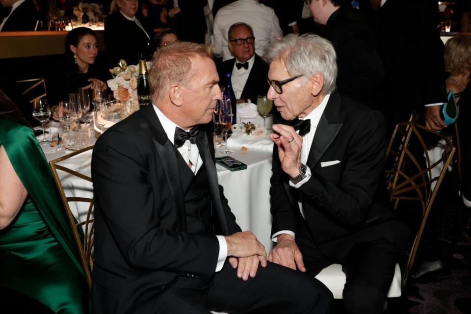 see the photos of kevin costner from yellowstone and harrison ford from 1923 chatting at the golden globe awards