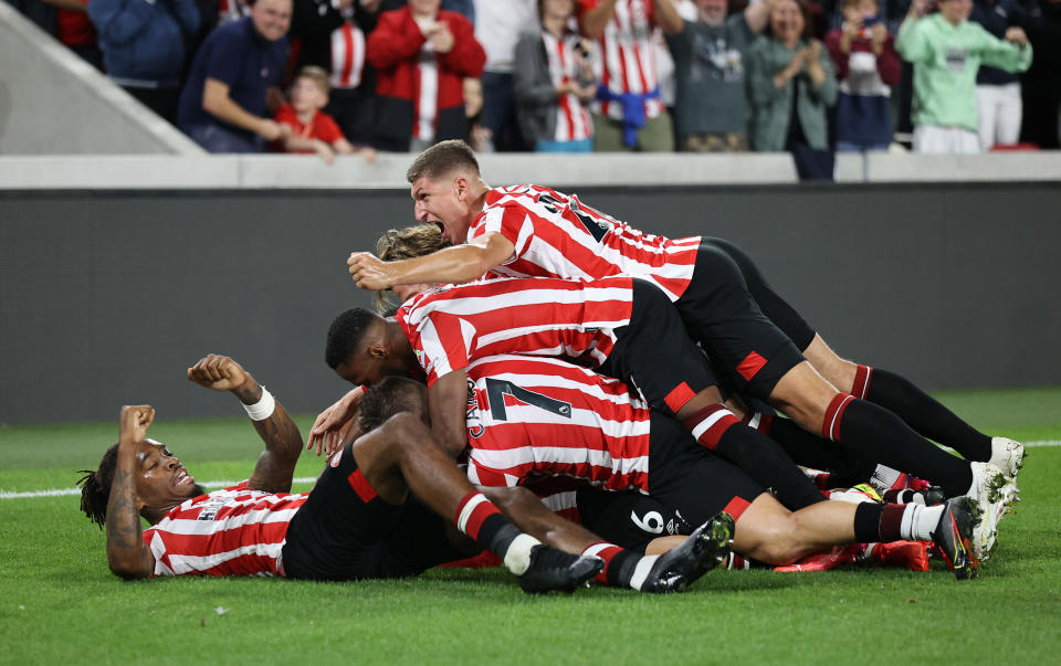 Pictured here, Brentford players celebrate during their season-opening win against Arsenal. 