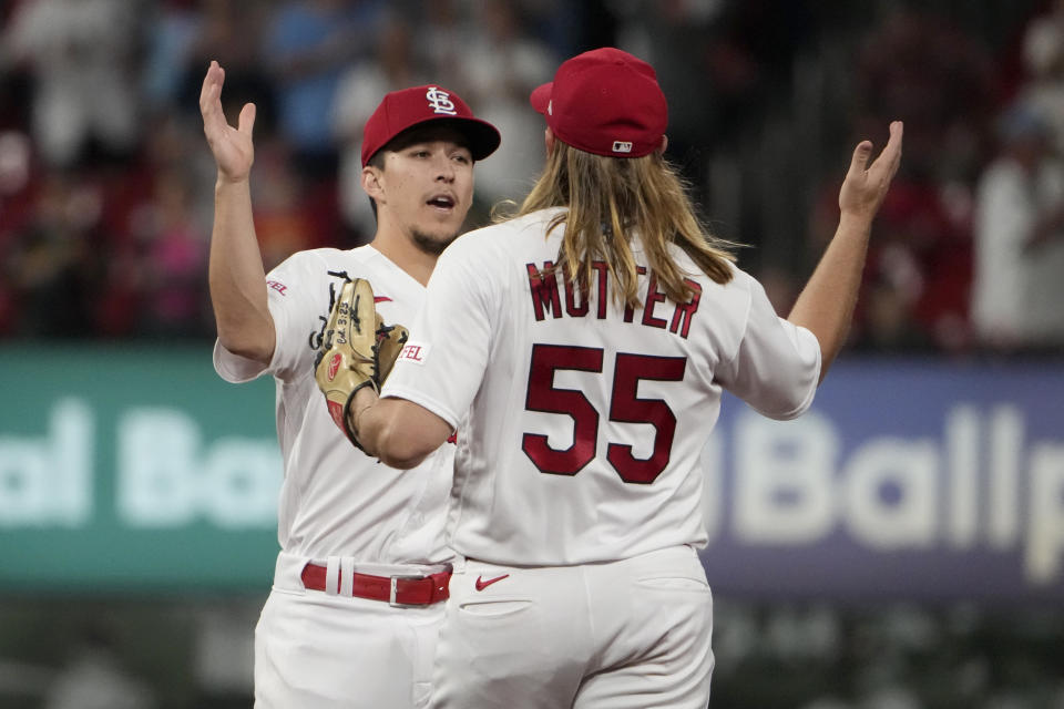 St. Louis Cardinals' Tommy Edman and Taylor Motter (55) celebrate a 6-2 victory over the Oakland Athletics in a baseball game Tuesday, Aug. 15, 2023, in St. Louis. (AP Photo/Jeff Roberson)