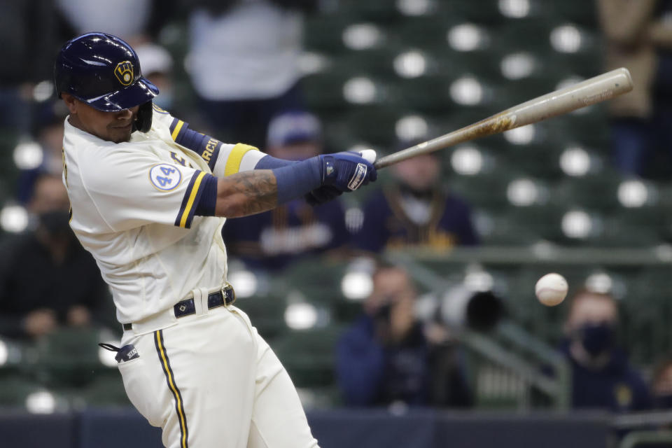 CORRECTS TO HITS AN INFIELD GROUND BALL TO DRIVE IN THE WINNING RUN - Milwaukee Brewers' Orlando Arcia hits an infield ground ball to drive in the winning run during the 10th inning of an opening day baseball game against the Minnesota Twins, Thursday, April 1, 2021, in Milwaukee. (AP Photo/Aaron Gash)
