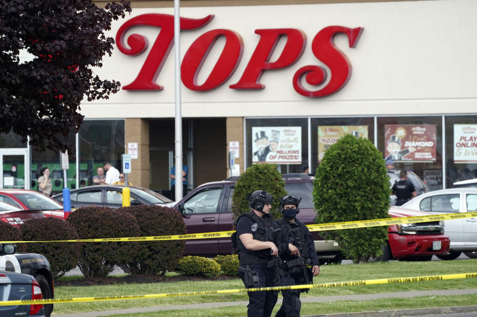 FILE - Police secure an area around a supermarket where several people were killed in a shooting, May 14, 2022 in Buffalo, N.Y. Victims and relatives of last year's mass shooting at a Buffalo supermarket announced Wednesday, July 12, 2023, they are suing the social media sites, gun seller, gunman's parents and others who they say "loaded the gun" the assailant used to kill 10 Black people and wound three other victims. (Derek Gee/The Buffalo News via AP, File)
