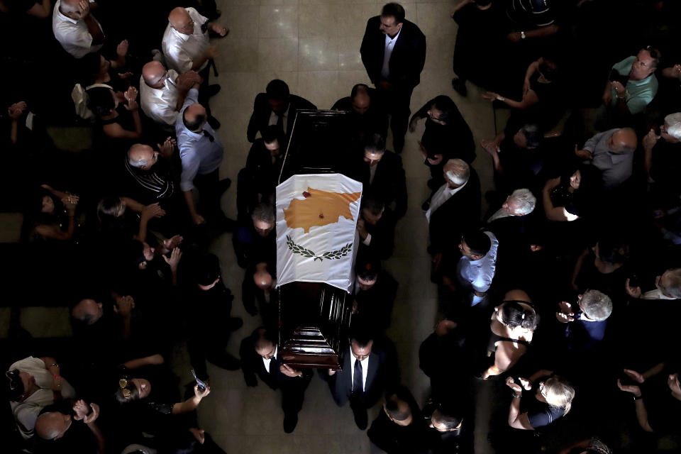 Pallbearers carry the coffin of the former Cyprus' President Dimitris Christofias during his state funeral at the Orthodox Christian Church of the Lord's Wisdom in capital Nicosia, Cyprus, Tuesday, June 25, 2019. European communist and left-wing party heads and leaders from ethnically split Cyprus' breakaway Turkish Cypriot community were among those attending a funeral service for the country's former president Christofias. (AP Photo/Petros Karadjias)