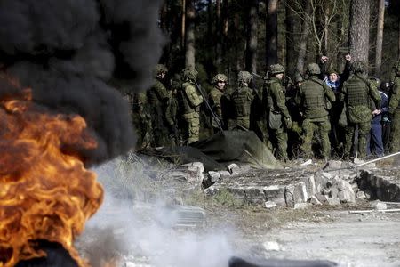 The Lithuanian Army rapid reaction force unit carries out an anti-riot drill in Rukla, Lithiuania, in this March 19 file picture, 2015. REUTERS/Ints Kalnins/Files