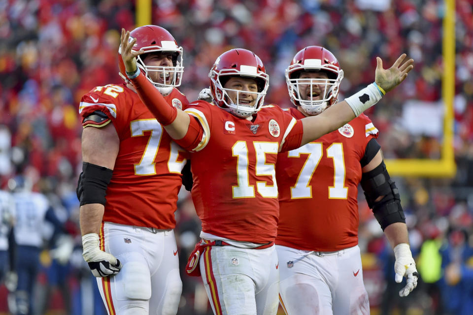 Kansas City Chiefs' Patrick Mahomes (15) celebrates a touchdown pass with Eric Fisher (72) and Mitchell Schwartz (71) during the second half of the NFL AFC Championship football game against the Tennessee Titans Sunday, Jan. 19, 2020, in Kansas City, MO. (AP Photo/Ed Zurga)