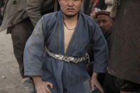 An Afghan men prepares to compete a wrestling match in Kabul, Afghanistan, Friday, Dec. 3 , 2021. The scene is one played out each week after Friday prayers in the sprawling Chaman-e-Huzori park in downtown Kabul, where men, mainly from Afghanistan's northern provinces, gather to watch and to compete in pahlawani, a traditional form of wrestling. (AP Photo/ Petros Giannakouris)