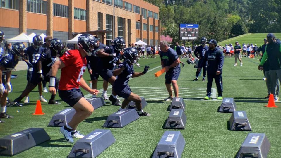 Undrafted free-agent quarterback Holton Ahlers (in red) and offensive players run through the Seahawks’ bag drill on the first day of rookie minicamp at the Virginia Mason Athletic Center in Renton May 12, 2023.