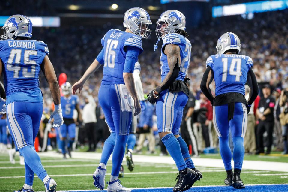 Detroit Lions running back Jahmyr Gibbs (26) celebrates a touchdown against Tampa Bay Buccaneers with quarterback Jared Goff (16) during the second half of the NFC divisional round at Ford Field in Detroit on Sunday, Jan. 21, 2024.