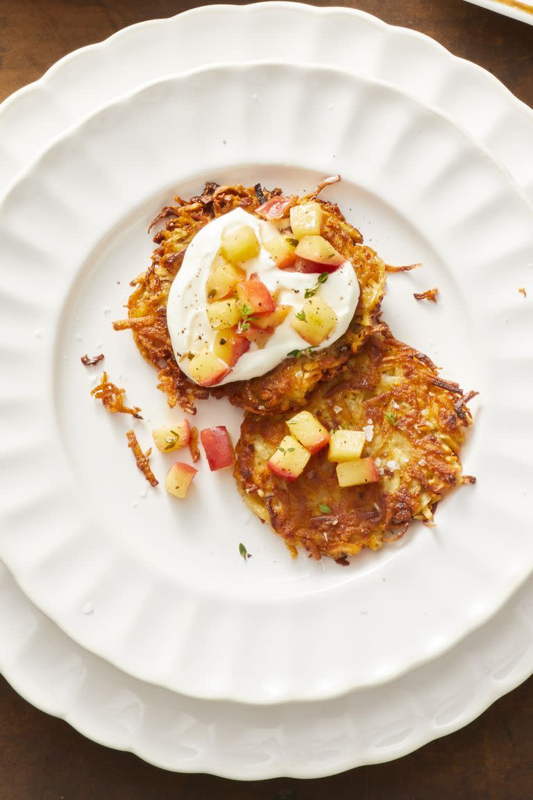 parsnip potato latkes with sauteed apples on a white plate