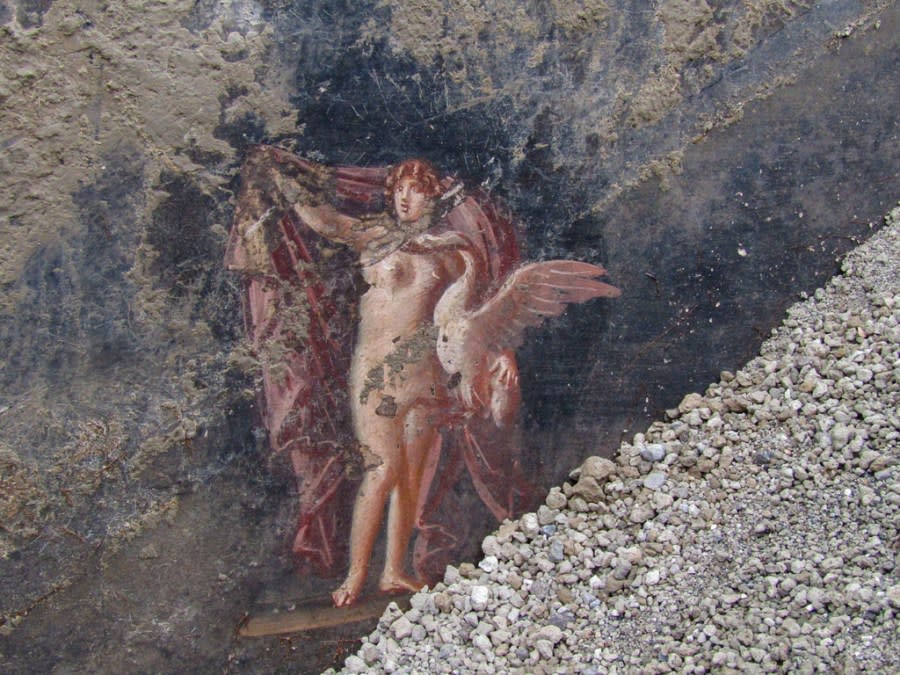 This image released by the Italian Culture Ministry on Wednesday, April 10, 2024, shows, part of the frescoes inside an imposing banquet hall, with elegant black walls, decorated with mythological subjects inspired by the Trojan War, which was recently unhearted in the Pompeii archaeological area near Naples in southern Italy. (Italian Culture Ministry via AP, HO)