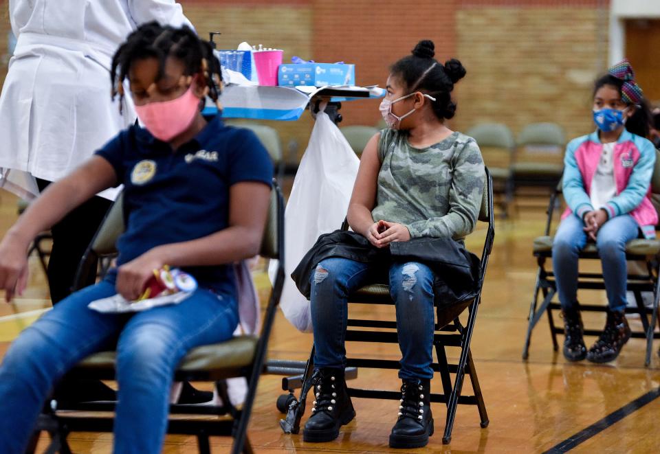 Jaylie Pierre, from front, Aiden Roth and Peyton Roth get their COVID-19 vaccines during a Vaccine Clinic for students, aged 5-11, on the ASU campus in Montgomery, Ala., on Friday January 21, 2022. The clinic was put on in partnership between Alabama State University, Montgomery Public Schools and the Alabama Department of Public Health. 