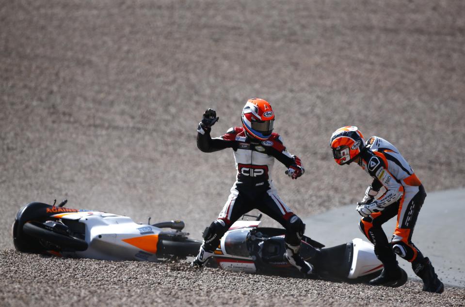 Mahindra Moto3 rider Bryan Schouten of the Netherlands fights with compatriot Kalex KTM Moto3 rider Scott Deroue (R) after they crashed during the German Grand Prix at the Sachsenring circuit in the eastern German town of Hohenstein-Ernstthal in this July 13, 2014 file photo. REUTERS/Thomas Peter/Files (GERMANY - Tags: TPX IMAGES OF THE DAY SPORT)