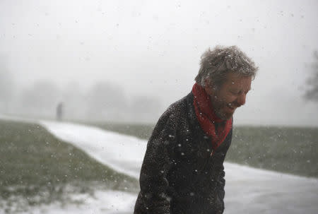 A man walks through a snow flurry on Primrose Hill in London, Britain February 27, 2018. REUTERS/Peter Nicholls TPX IMAGES OF THE DAY