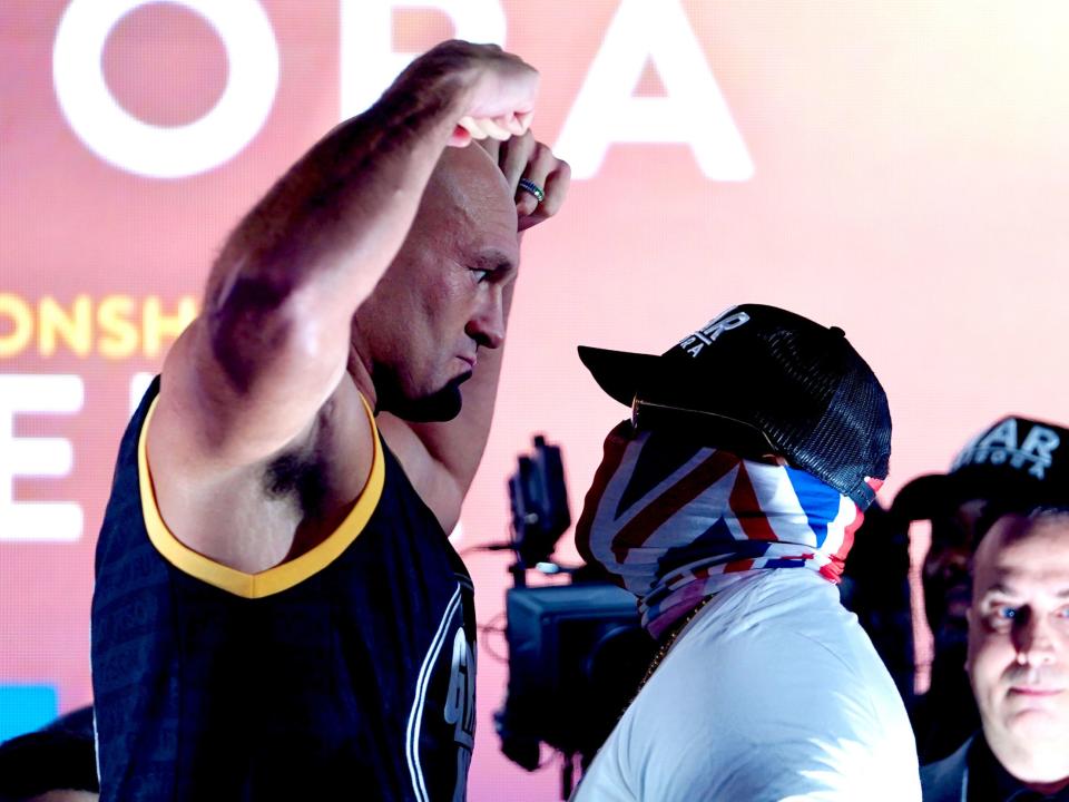 Tyson Fury faces off with challenger Derek Chisora at the weigh-ins for their title fight (PA)