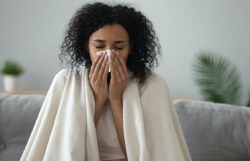 <span class="caption">The common cold is usually caused by a rhinovirus.</span> <span class="attribution"><a class="link " href="https://www.shutterstock.com/image-photo/ill-african-young-woman-covered-blanket-1444224857" rel="nofollow noopener" target="_blank" data-ylk="slk:Shutterstock/fizkes;elm:context_link;itc:0;sec:content-canvas">Shutterstock/fizkes</a></span>