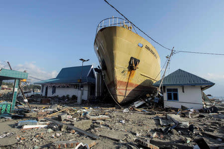 A ship is seen stranded on the shore after an earthquake and tsunami hit the area in Wani, Donggala, Central Sulawesi, Indonesia October 1, 2018 in this photo taken by Antara Foto. Antara Foto/Muhammad Adimaja/ via REUTERS