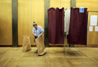 A cleaner replaces a garbage bag in a polling station during the second round of 2017 French presidential election in Paris, France, May 7, 2017. REUTERS/Kevin Coombs