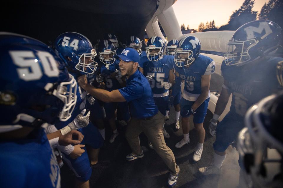 McNary quarterback coach Kyle McGrath excites players before the Sept. 30 game against North Salem.