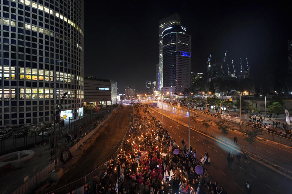 People march in a protest against Prime Minister Benjamin Netanyahu and his his far-right government that his opponents say threaten democracy and freedoms, in Tel Aviv, Israel, Saturday, Jan. 21, 2023. (AP Photo/ Tsafrir Abayov)