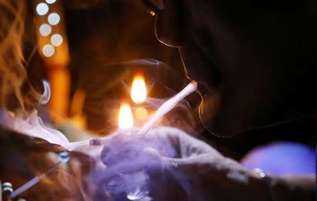 A drug user inhales "Shabu", or methamphetamine, at a drug den in Manila, Philippines February 13, 2017. REUTERS/Erik De Castro