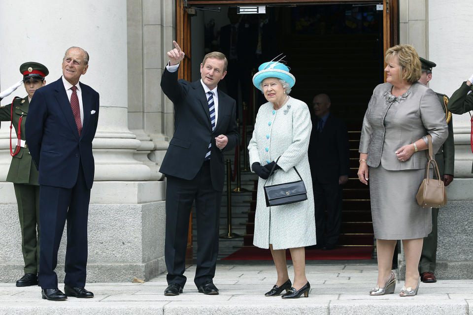 FILE - Britain's Queen Elizabeth II, centre right and Prince Philip, left, are greeted by Irish Prime Minister Enda Kenny and his wife Fionnala, right, at Government Buildings in Dublin, Wednesday, May 18, 2011. Queen Elizabeth II, Britain’s longest-reigning monarch and a rock of stability across much of a turbulent century, has died. She was 96. Buckingham Palace made the announcement in a statement on Thursday Sept. 8, 2022. (Pool via AP, File)