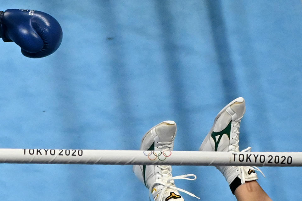 <p>Japan's Sena Irie falls during her bout against Tunisia's Khouloud Hlimi Ep Moulahi during their women's feather (54-57kg) preliminaries round of 16 boxing match on July 26.</p>