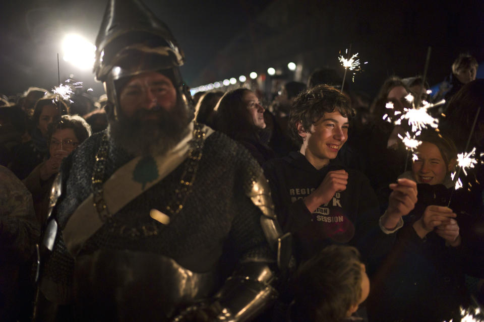 A man dressed like a Middle Age soldier, left, attends ceremonies marking the 600th anniversary of the birth of Joan of Arc, in Orleans, central France, Sunday April 29, 2012. The city of Orleans goes all out with celebrations marking the 600th birthday of Joan of Arc, a national icon and symbol of French resistance through the ages at a time when French identity and France's role in the world are a focus in the presidential campaign. (AP Photo/Thibault Camus)