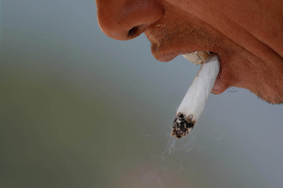 <p>A man smokes a cigarette whilst working on the reconstruction of the Jiankou section of the Great Wall, located in Huairou District, north of Beijing, China, June 7, 2017. (Photo: Damir Sagolj/Reuters) </p>