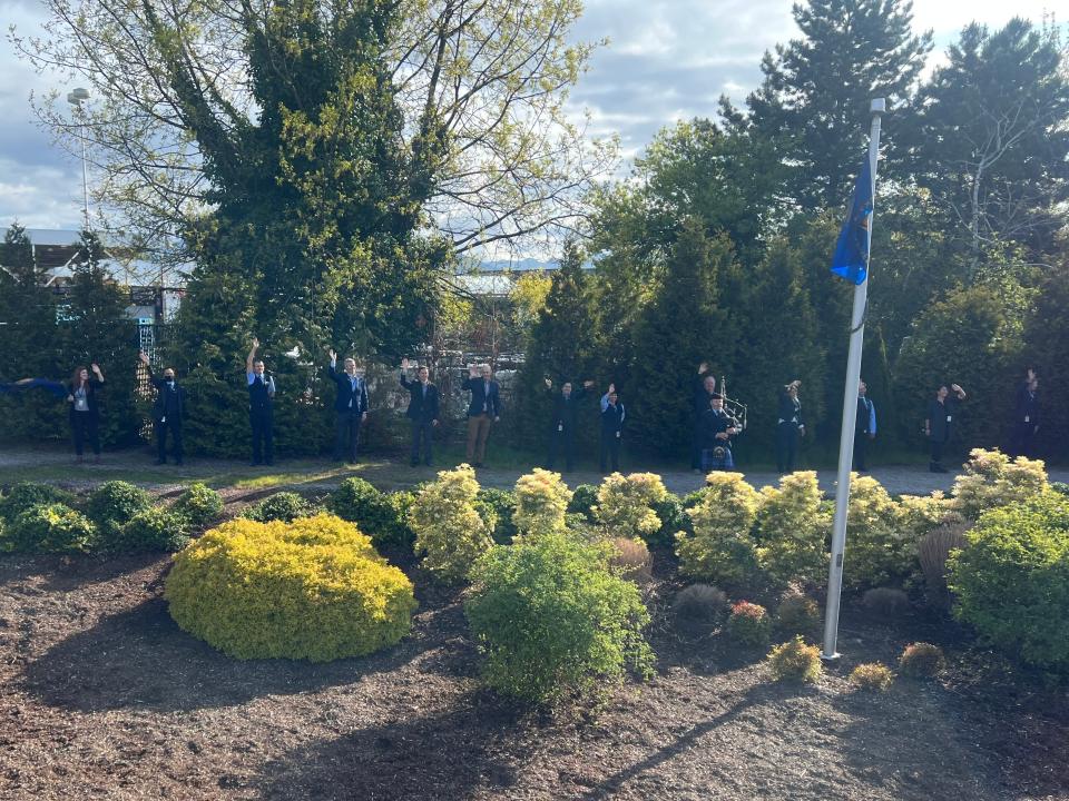 Rocky Mountaineer staff members waving train away at train station