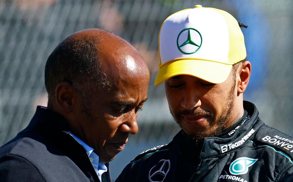 Sir Lewis Hamilton celebrates with his father Anthony after winning the British Grand Prix