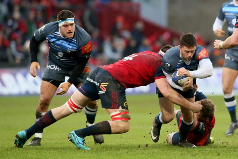 Castres' scrum-half Rory Kockott (R) is tackled by Munster's lock Jean Kleyn during the European Champions Cup Pool 4 rugby union match at Thomond Park in Limerick, Ireland on January 21, 2018